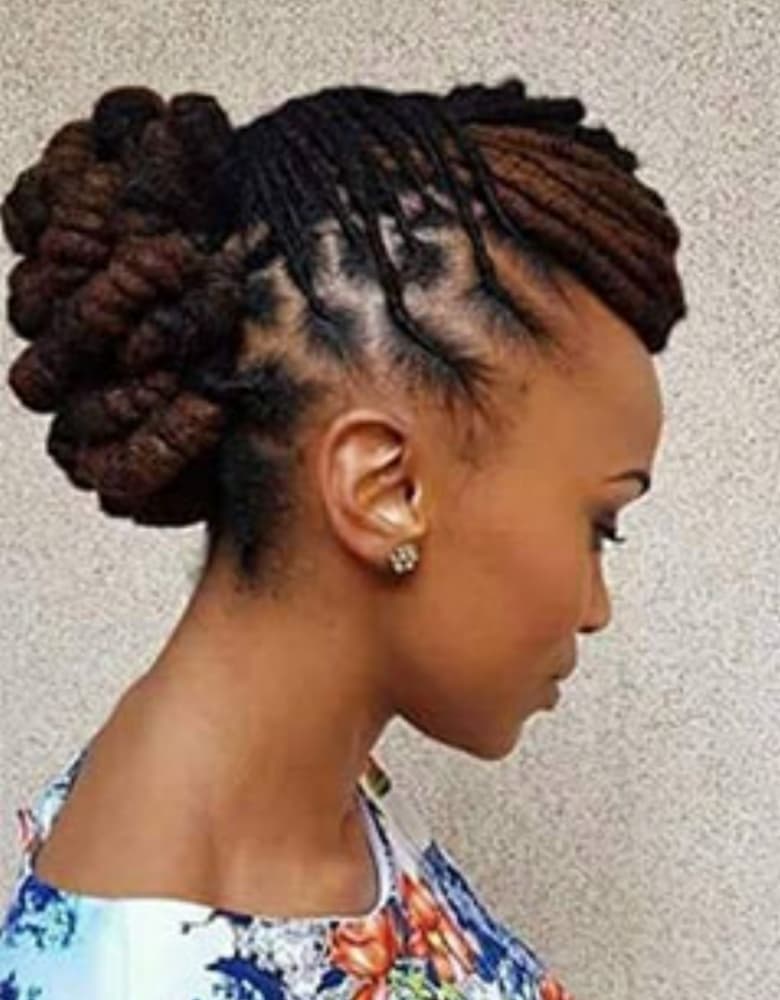 Loc updo arranged into sculptural side buns