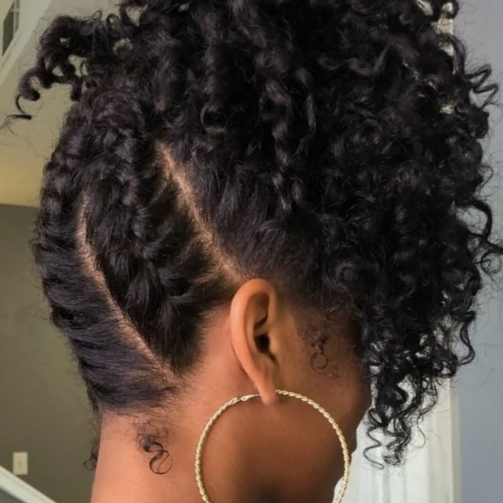 Natural updo with defined curls and curved cornrow detail
